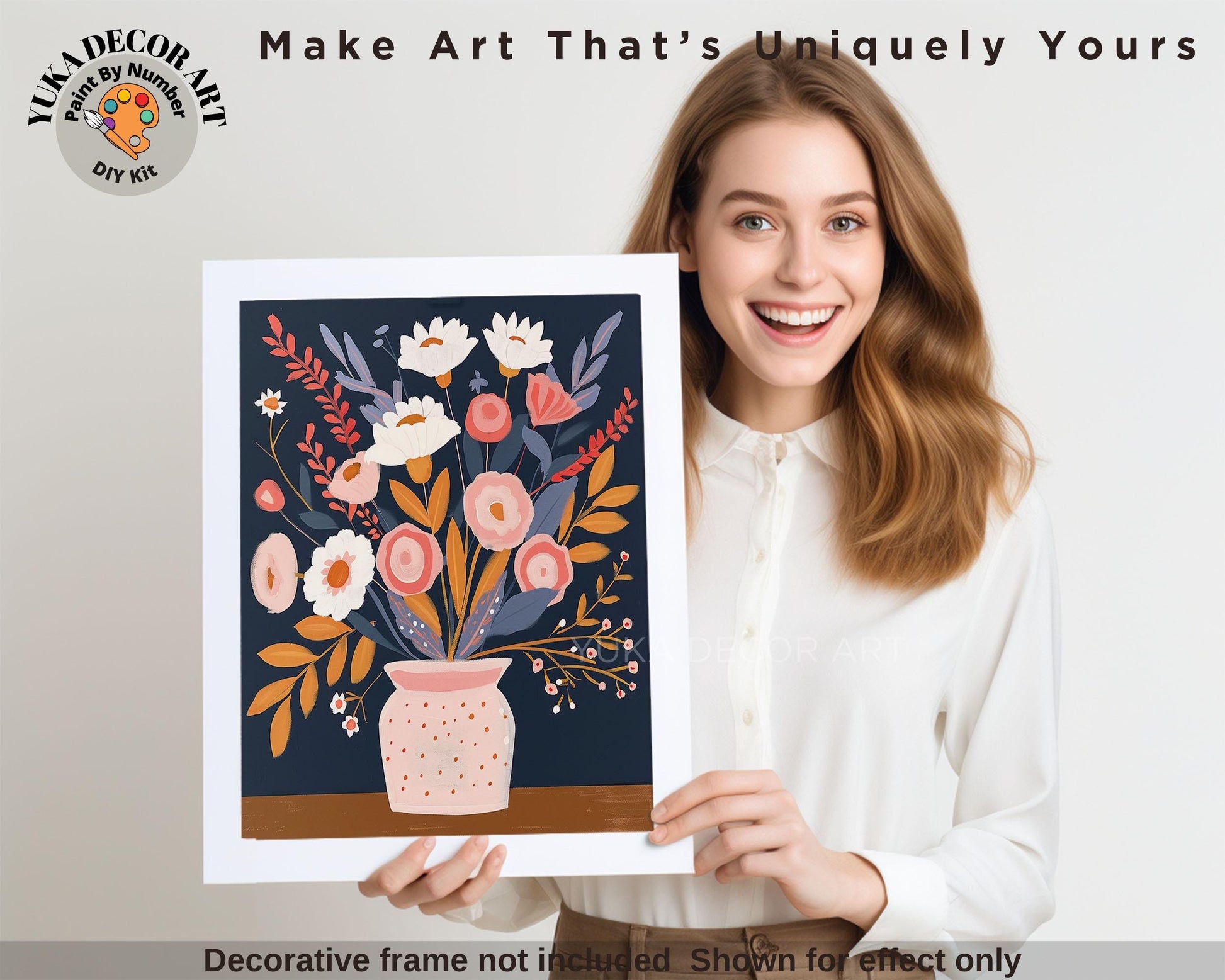 a woman holding a picture of a vase of flowers
