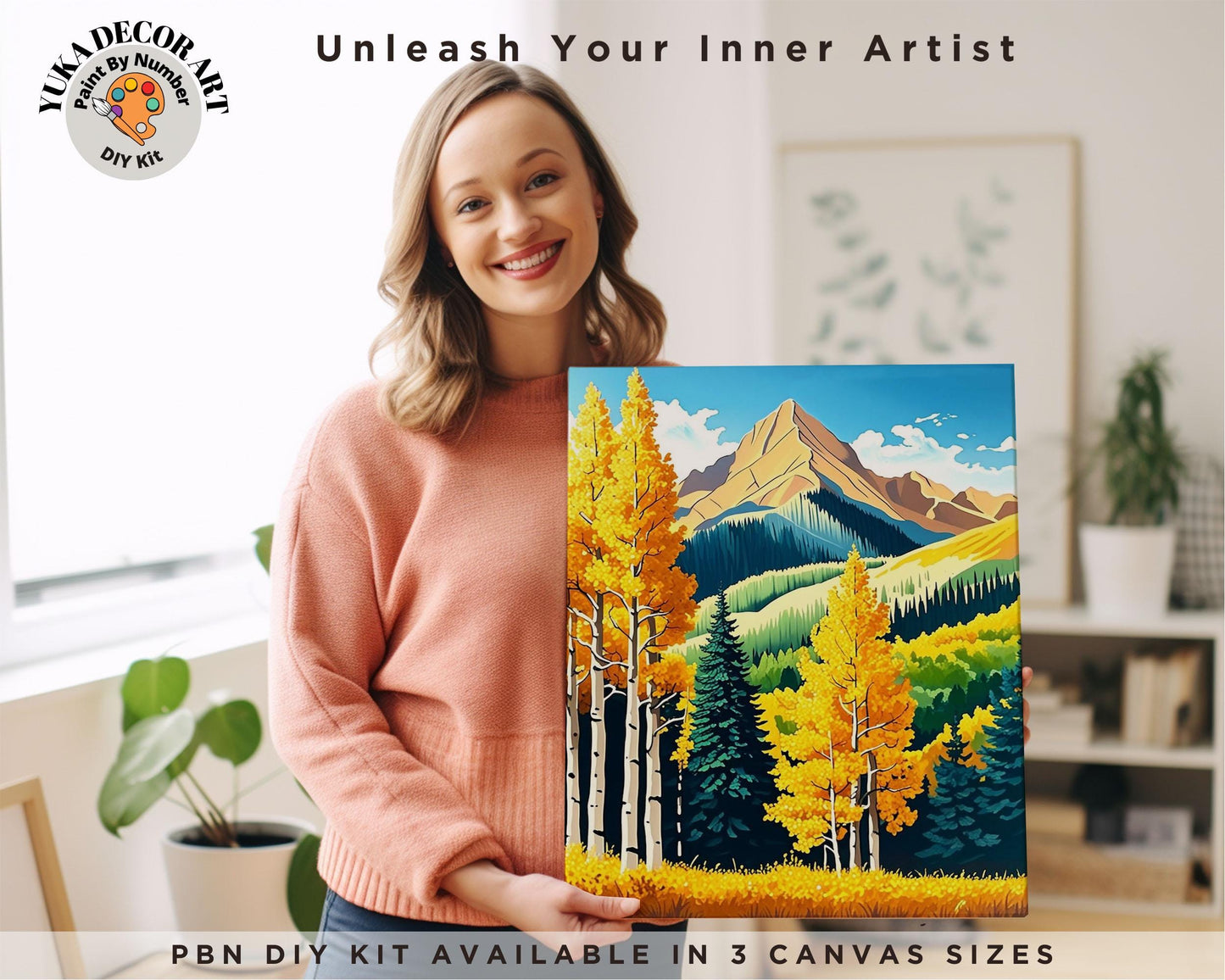 a woman holding a painting of a mountain scene