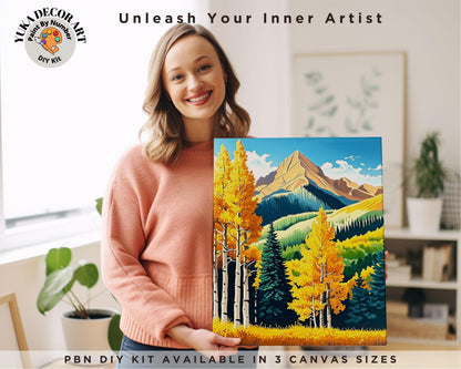 a woman holding a painting of a mountain scene
