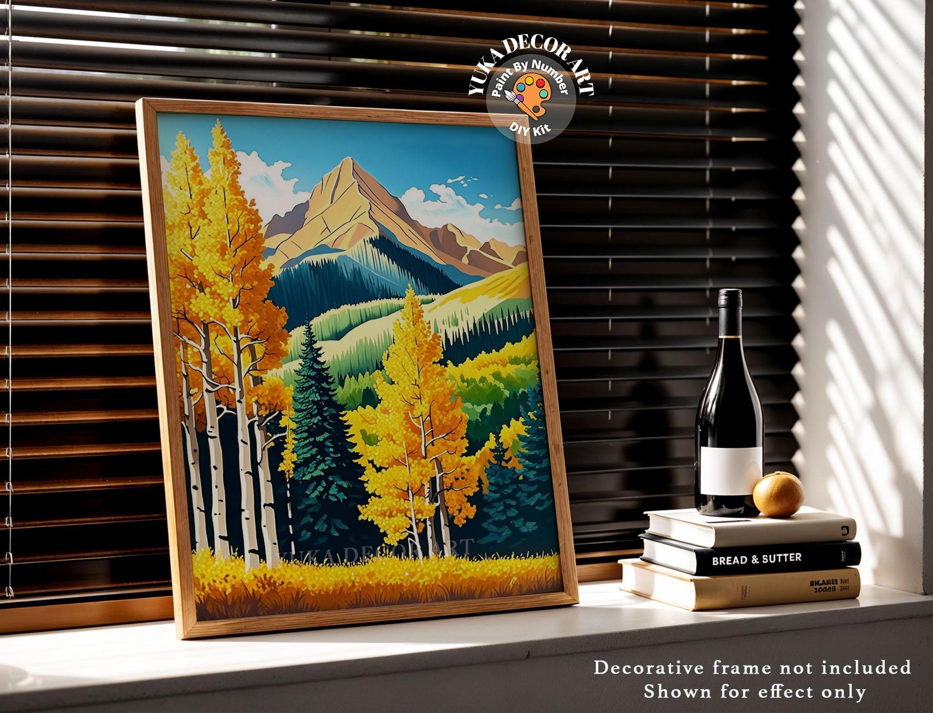 a painting on a window sill next to a bottle of wine