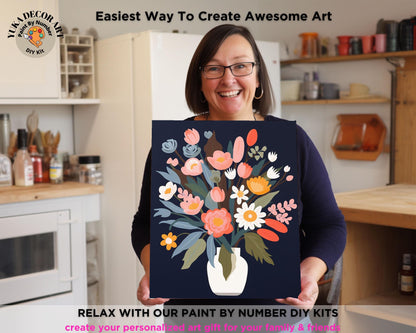 a woman holding a painting of flowers in a vase